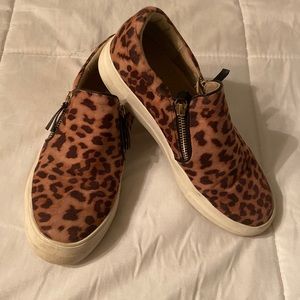 Cheetah print slip on shoes.